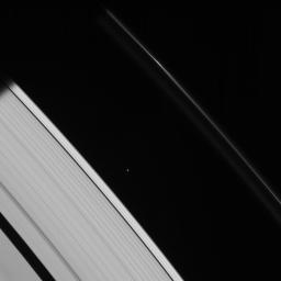 This strikingly crisp view shows Atlas heading into Saturn's shadow at upper left. The moon's basic, elongated shape is easy to detect as seen by NASA's Cassini spacecraft.