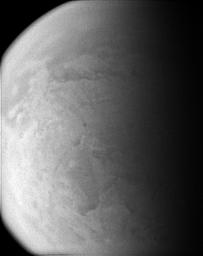 Straining to make out the surface of Titan through its murky atmosphere, NASA's Cassini spacecraft's wide angle camera manages to exploit one of the infrared spectral windows where the particulate smog is transparent enough for a peek.