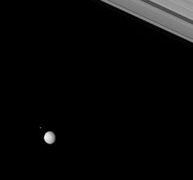 Two moons of Saturn, Pan and Pandora, rendezvous in the Saturnian skies above NASA's Cassini spacecraft.
