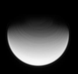 The rapidly rotating clouds above Titan's northernmost latitudes stretch into streaks that circumscribe the pole. The ultraviolet spectral filter used to take this image allows NASA's Cassini spacecraft to view the moon's stratosphere.