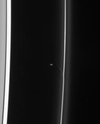 Saturn's shepherd moon Prometheus draws a fresh streamer of material from the F ring as it passes the ring's interior edge as seen by NASA's Cassini spacecraft.
