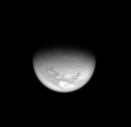 From high above Titan's northern hemisphere, NASA's Cassini spacecraft takes an oblique view toward the mid-latitude dark regions that gird the giant moon.