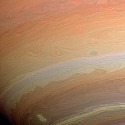 Whorls, streamers and eddies in hues of orange, yellow, and tan play in the banded atmosphere of the gas giant, Saturn. This image was taken with NASA's Cassini spacecraft's wide-angle camera.