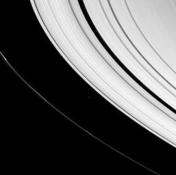 A small icy world plies the space between Saturn's A and F rings as seen by NASA's Cassini spacecraft.