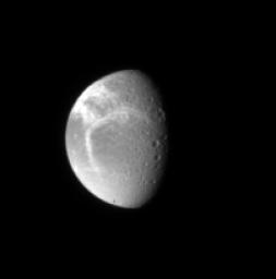 NASA's Cassini spacecraft spies bright fractures in the icy crust of Dione. This view looks toward the northern hemisphere on Dione's anti-Saturn side.