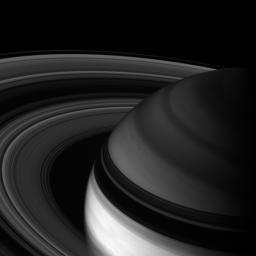 NASA's Cassini spacecraft looks toward northern latitudes on Saturn and out across the ringplane. This infrared view probes clouds beneath the hazes that obscure the planet's depths in natural color views