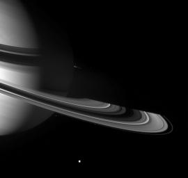Graceful giant Saturn poses with a few of the small worlds it holds close. From this viewpoint NASA's Cassini spacecraft can see across the entirety of the planet's shadow on the rings, to where the ringplane emerges once again into sunlight.