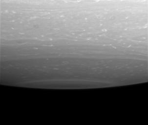 Storms ringed by bright clouds swirl near the south pole of Saturn. This lateral view from NASA's Cassini spacecraft captures the bull's-eye pattern that surrounds the pole, where a monstrous, hurricane-like storm resides.
