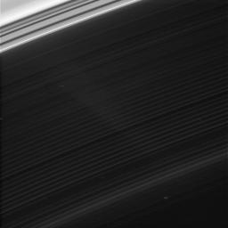 Faint features in Saturn's innermost ring, the D ring, are brought into view in this strongly contrast-enhanced image from NASA's Cassini spacecraft. A few background stars are visible through the sheer ring as squiggly star trails.