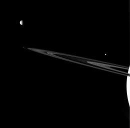 Three of Saturn's brood are captured near the rings in this view from NASA's Cassini spacecraft. Together they showcase the rich variety of worlds found in the Saturn system.