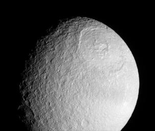 NASA's Cassini spacecraft provides a stunning view of the Odysseus impact basin on Tethys. The enormous basin is 450 kilometers (280 miles) wide.