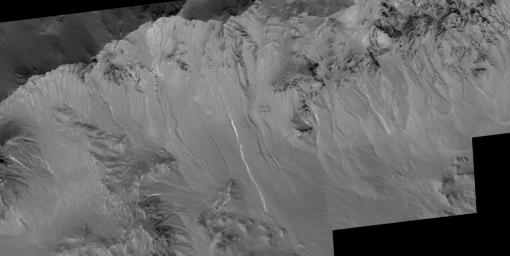 NASA's Mars Global Surveyor shows two examples of gullies on crater walls Terra Sirenum on Mars.