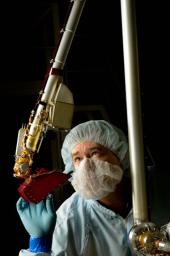 A spacecraft technician inspected the vital robotic arm of NASA's Phoenix Mars Lander during the assembly phase of the mission.