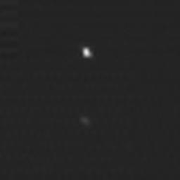 The two 'spots' in this image are a composite of two images of asteroid 2002 JF56 taken on June 11 and June 12, 2006, with the Multispectral Visible Imaging Camera component of the New Horizons Ralph imager.