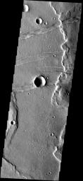 This image from NASA's Mars Odyssey spacecraft shows fractures in part of Memnonia Fossae. Large wrinkle ridges are being cut by the fractures.
