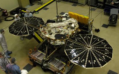 In this photograph of NASA's Phoenix Mars Lander, the spacecraft specialists worked on the lander after its fan-like circular solar arrays had been spread open for testing. 
