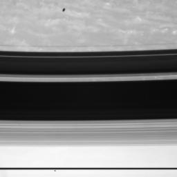Two of Saturn's moons make appearances in this view in very different ways; Janus and Mimas captured by NASA's Cassini spacecraft.