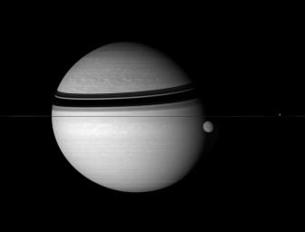 This stirring scene captures some of the grandeur of the Saturn system while also allowing a simultaneous glimpse beneath the hazes that cover both Saturn and Titan. This image was taken with NASA's Cassini spacecraft's wide-angle camera on Aug. 1, 2007.