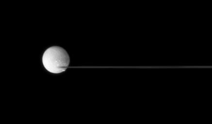 Saturn's nearly edge-on rings are caught between two moons, Dione and Pandora taken by NASA's Cassini spacecraft.
