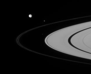 Three of Saturn's closest-orbiting moons are captured here, rounding the rings. They include Atlas, Pandora, and Mimas, captured by NASA's Cassini spacecraft on Sept. 6, 2007.