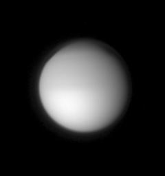 A hazy orb hangs in space, swathed in its dense cocoon of frigid atmosphere. Titan's global, detached, high-altitude haze layer is visible in this image captured by NASA's Cassini spacecraft.