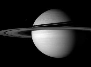 Icy sentinels Tethys and Enceladus stand guard on Saturn's doorstep, defying the distant Sun in this image captured by NASA's Cassini spacecraft on Sept. 20, 2007.