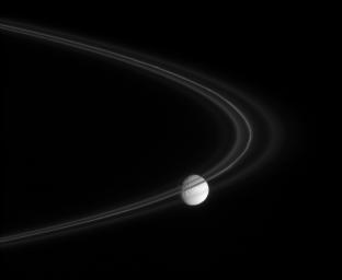 NASA's Cassini spacecraft peers through the fine, smoke-sized ice particles of Saturn's F ring toward the cratered face of Mimas in this captured on Nov. 18, 2007.