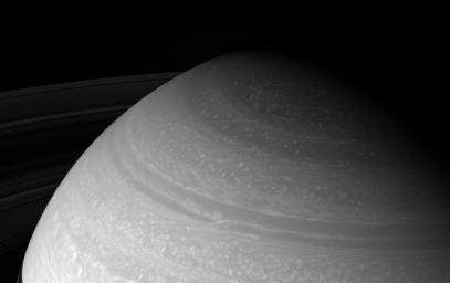 NASA's Cassini spacecraft looks toward high northern latitudes on Saturn and the wild cloud forms that swirl there. The view was taken from about 23 degrees above the ringplane and looks toward the unilluminated side of the rings.