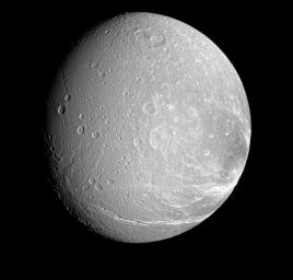 Bright, icy canyons stretch across the surface of Dione. This view from NASA's Cassini spacecraft looks toward the Saturn-facing side of Dione.