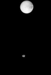 On Jan. 17, 2008, NASA's Cassini spacecraft captured Saturn's moon, Janus, in the foreground, with Dione in the distance beyond.
