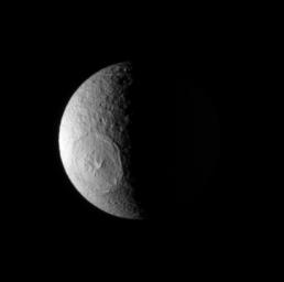 NASA's Cassini spacecraft looks down onto high northern latitudes on Tethys, spying the enormous impact basin Odysseus. Lit terrain seen here is on the anti-Saturn side of Tethys (1,071 kilometers, or 665 miles across).