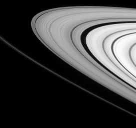 The embedded moon Daphnis is seen in its narrow gap at lower right. The tiny moon is accompanied by its entourage of edge waves, visible as ripples in the gap's edges in this image taken by NASA's Cassini spacecraft on March 4, 2009.