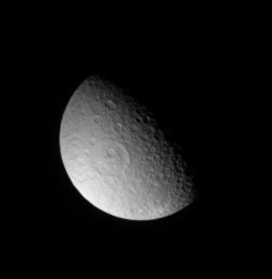 NASA's Cassini spacecraft takes a northern view of Rhea, spying the large Tirawa impact basin left of center.