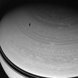 Myriad vortices churn through Saturn's high northern latitudes while Saturn's moon Dione's shadow drifts across the gas giant's face. This image was taken with NASA's Cassini spacecraft's wide-angle camera on May 7, 2008.