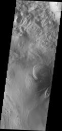 This image from NASA's Mars Odyssey shows the region of Ophir Chasma on Mars containing old landslide deposits and layered deposits. Wind and perhaps water have sculpted the layered deposits.