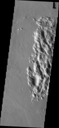 This image from NASA's Mars Odyssey shows a complex of hills and surrounding lava flows located northeast of Olympus Mons.