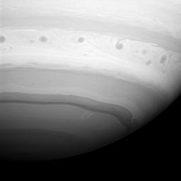 A line of dark vortices charge through Saturn's 'Storm Alley,' a region that has seen intensive storm activity since NASA's Cassini spacecraft began its observations of the planet in early 2004.