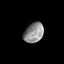 Bright fractures adorn the trailing side of Saturn's moon Dione. This image from NASA's Cassini spacecraft looks toward the northern hemisphere of Dione (1,123 kilometers, or 698 miles across).