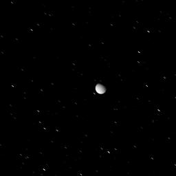 Tethys appears here, against a background of star trails, in a view acquired as the icy moon exited Saturn's shadow. This image was taken in visible light with NASA's Cassini spacecraft's wide-angle camera.