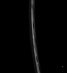 A train of diagonal channels in Saturn's F ring follows behind the moon Prometheus. Atlas appears at lower right. NASA's Cassini spacecraft captured this image on July 5, 2008.