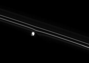 Brilliant Prometheus pulls at the nearby inner strand of Saturn's F ring. Gravitational tugs from Prometheus are constantly reshaping this narrow ring as seen by NASA's Cassini spacecraft.