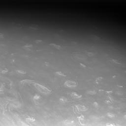 NASA's Cassini spacecraft continued to track Saturn's moon Prometheus after it disappeared behind the planet, capturing a few fortunate, high-resolution views of the clouds in Saturn's high north.