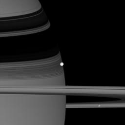 A trio of Saturn's icy moons, Enceladus, Pandora, and Mimas, crowds together along NASA's Cassini spacecraft's line of sight in this image captured on June 28, 2007.