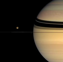 Four moons huddle near Saturn's multi-hued disk. Titan, Janus, Mimas, and Prometheus are captured in this image from NASA's Cassini spacecraft on Oct. 26, 2007.