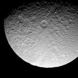 The prominent crater Telemachus sits within the northern reaches of Ithaca Chasma on Saturn's moon Tethys in this image captured by NASA's Cassini spacecraft on Sept. 24, 2008.