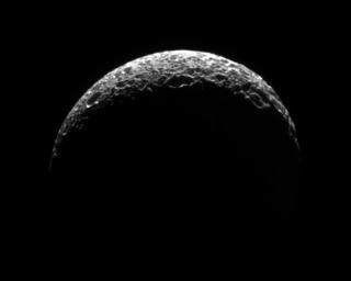Saturn's moon Mimas's lit crescent has the appearance of a golf ball thanks to its heavily cratered surface in this image captured by NASA's Cassini spacecraft on Oct. 24, 2008.