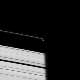 Prometheus emerges from Saturn's shadow in this image taken on Oct. 29, 2008 by NASA's Cassini spacecraft of the dark side of the rings.