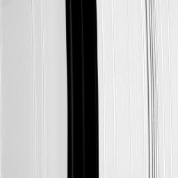 The Encke Gap, the broad, vertical dark band running down the center of this image from NASA's Cassini spacecraft, is maintained by the small moon Pan (not pictured). Pan also shepherds three ringlets which appear here as faint, narrow bands.