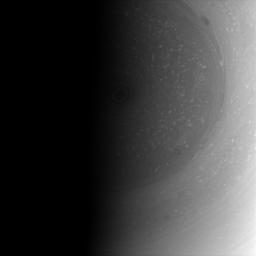 The terminator nearly covers the south pole of Saturn and its stormy vortex in darkness. This image was taken with NASA's Cassini spacecraft's wide-angle camera on Jan. 6, 2009.