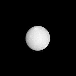 The face of Saturnian moon Dione is almost fully lit as NASA's Cassini spacecraft flies in between this moon and the sun with Dione at low phase. With a few hundred pixels of its digital camera, Cassini details dozens of craters a million kilometers away.